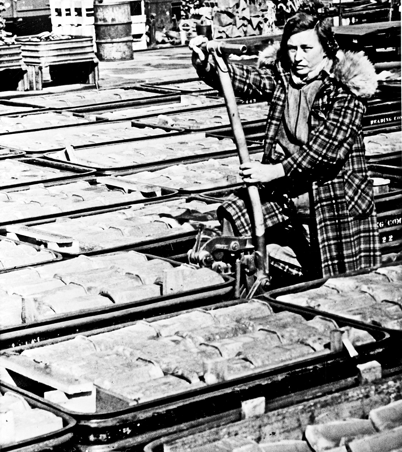Mrs. Maude T. Henry, of Mohrsville, operating a lift jack preparatory to moving a load of car journal bearings