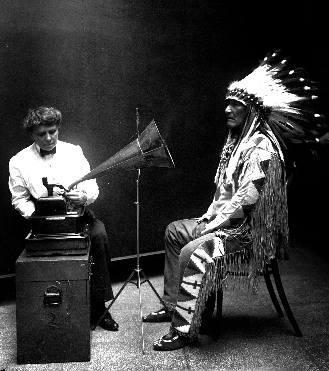 [Piegan Indian, Mountain Chief, listening to recording with ethnologist Frances Densmore]